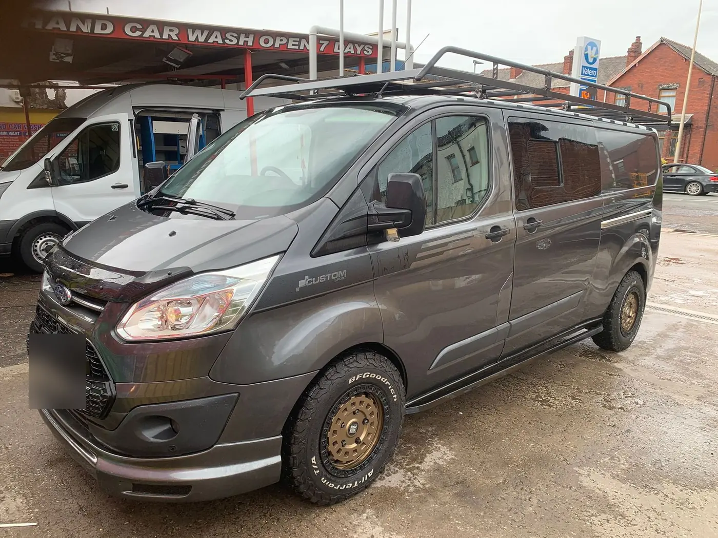 A grey Ford Transit Custom on gold wheels