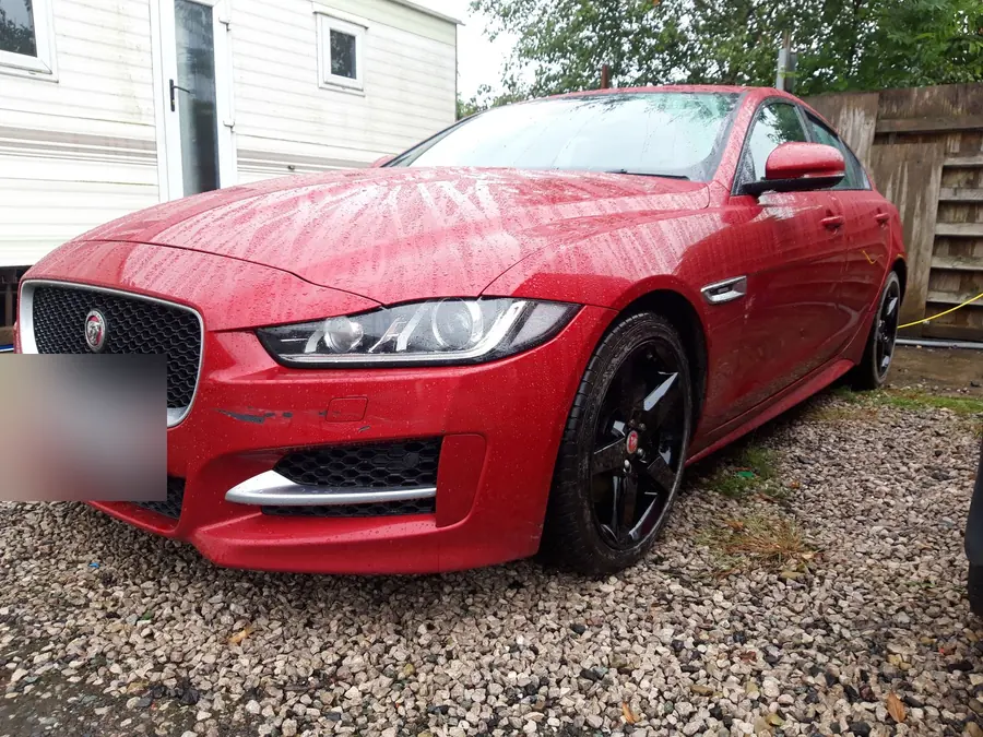 A red Jaguar XE on gloss black wheels