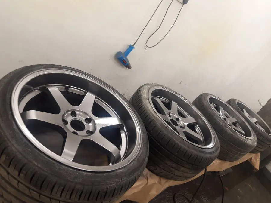 A set of gunmetal wheels lined up in our spray booth